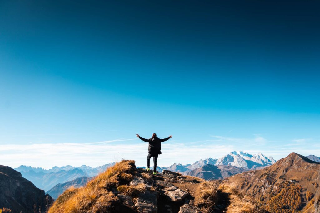 Man Standing on Top of The Mountain Free Photo