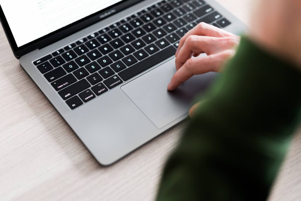 Man Using Touchpad on His Laptop Free Photo