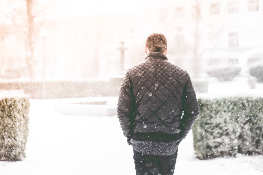 Man Walking in Snowfall Free Photo