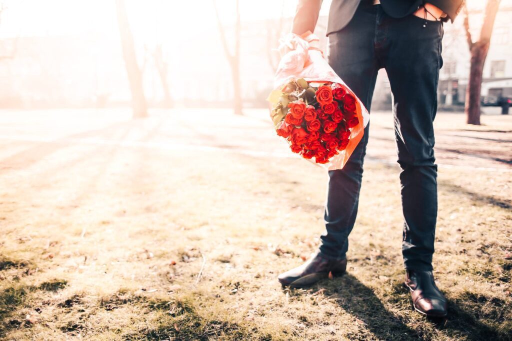 Man With Roses Waiting for his Lady Free Photo