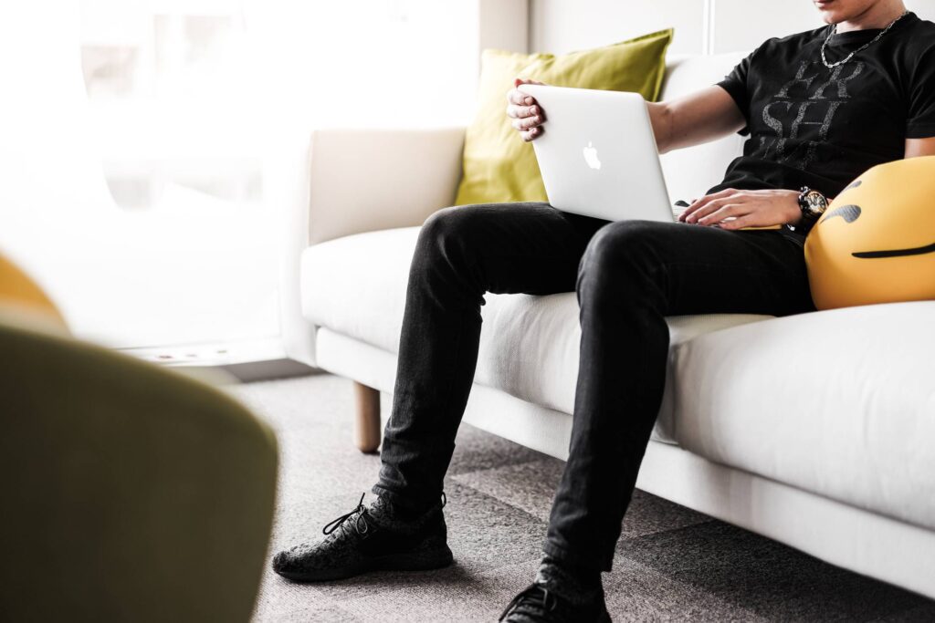 Man Working from the White Sofa in the Office Free Photo