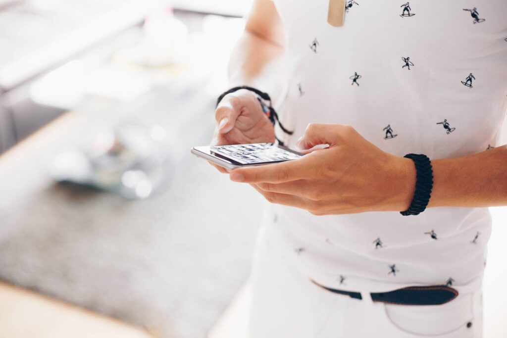 Man Working on iPhone while Walking Free Photo