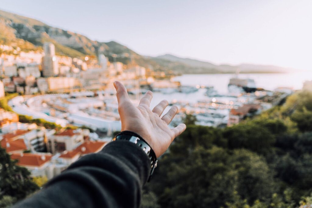 Man’s Hand Showing The City of Monaco Free Photo