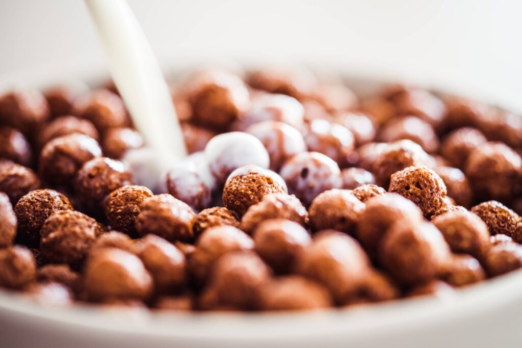 Milk Pouring on Cereal Chocolate Balls Free Photo