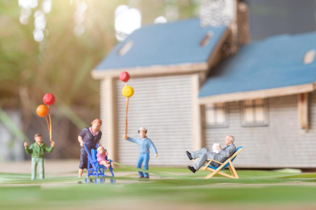 
									Miniature people, happy family playing in backyard lawn. Life at home concept Stock Free