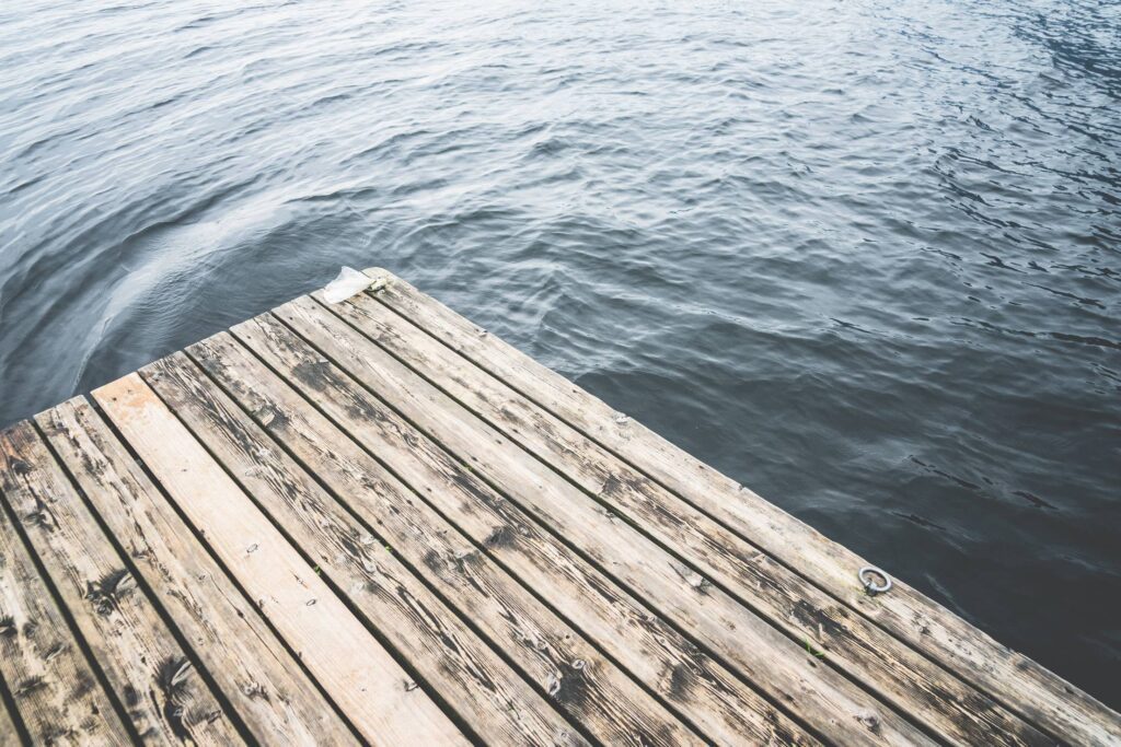 Minimalistic Shot of a Wooden Pier on a Lake Free Photo