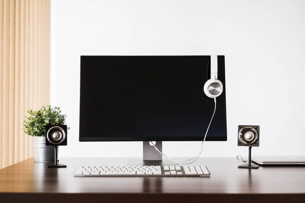 Modern Desktop Setup and White Headphones Free Photo