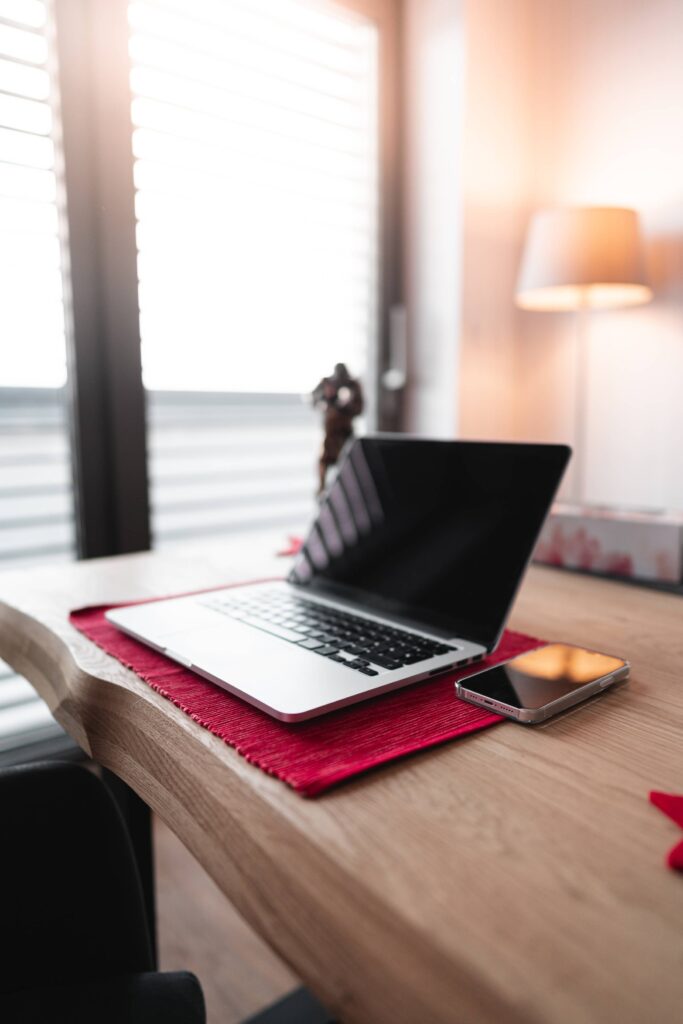 Modern Laptop and Smartphone on a Table at Home Free Photo