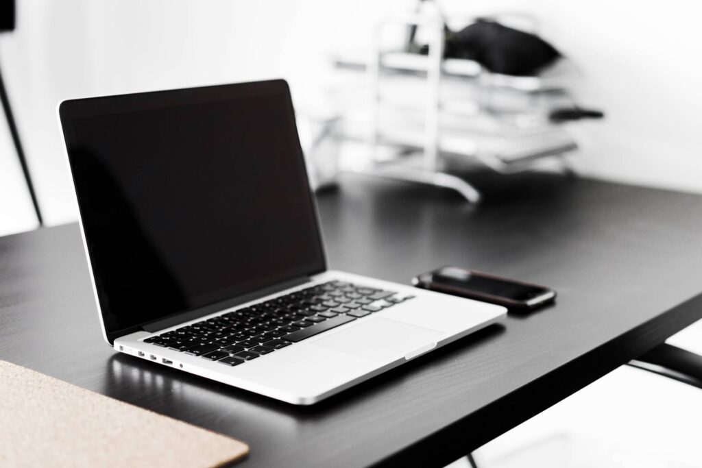 Modern Laptop and Smartphone on Black Desk Free Photo