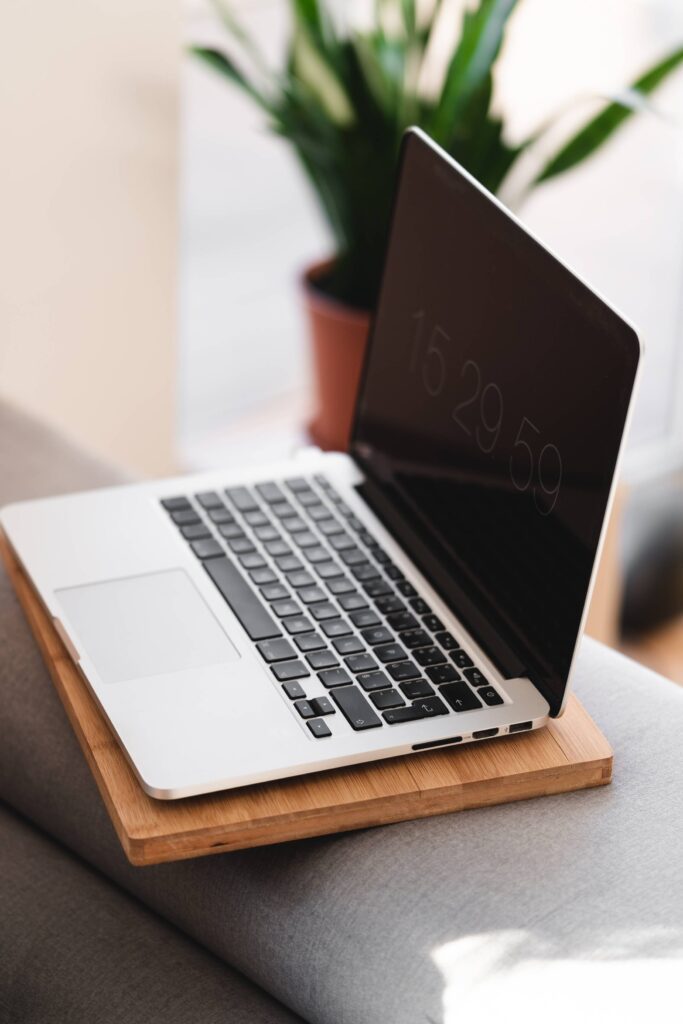 Modern MacBook Laptop on a Sofa at Home Free Photo