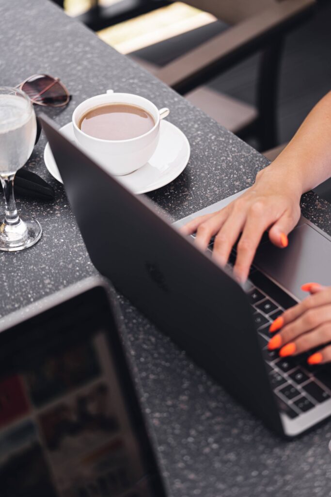 Nomad Woman Working Outside on Laptop with Morning Coffee Free Photo