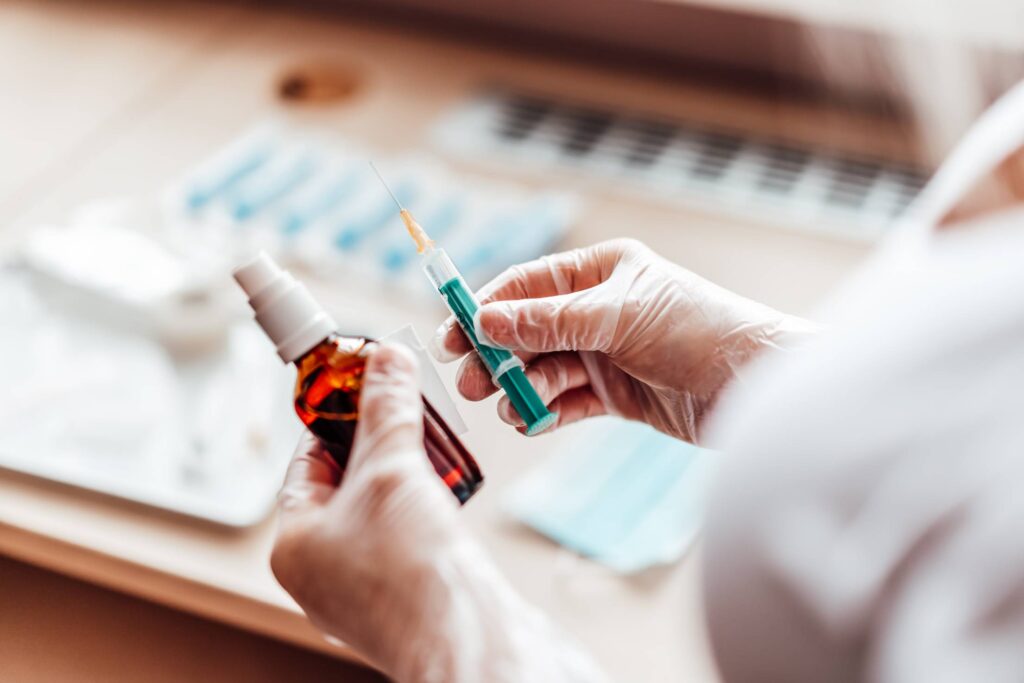 Nurse Holding a Syringe and Disinfection Free Photo