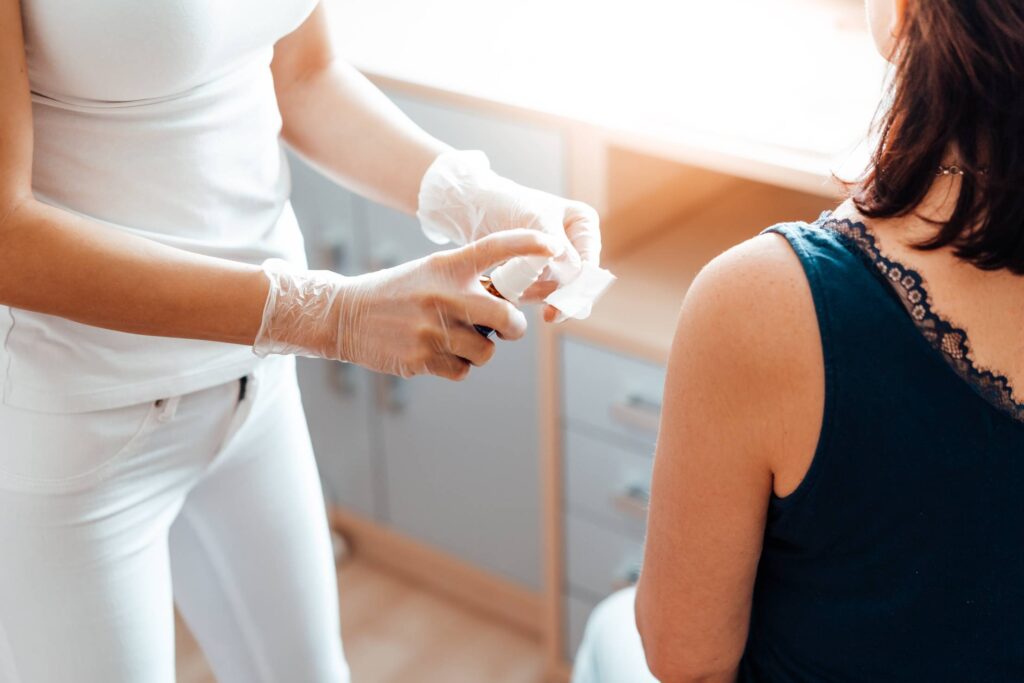 Nurse Preparing a Woman for Vaccination Free Photo