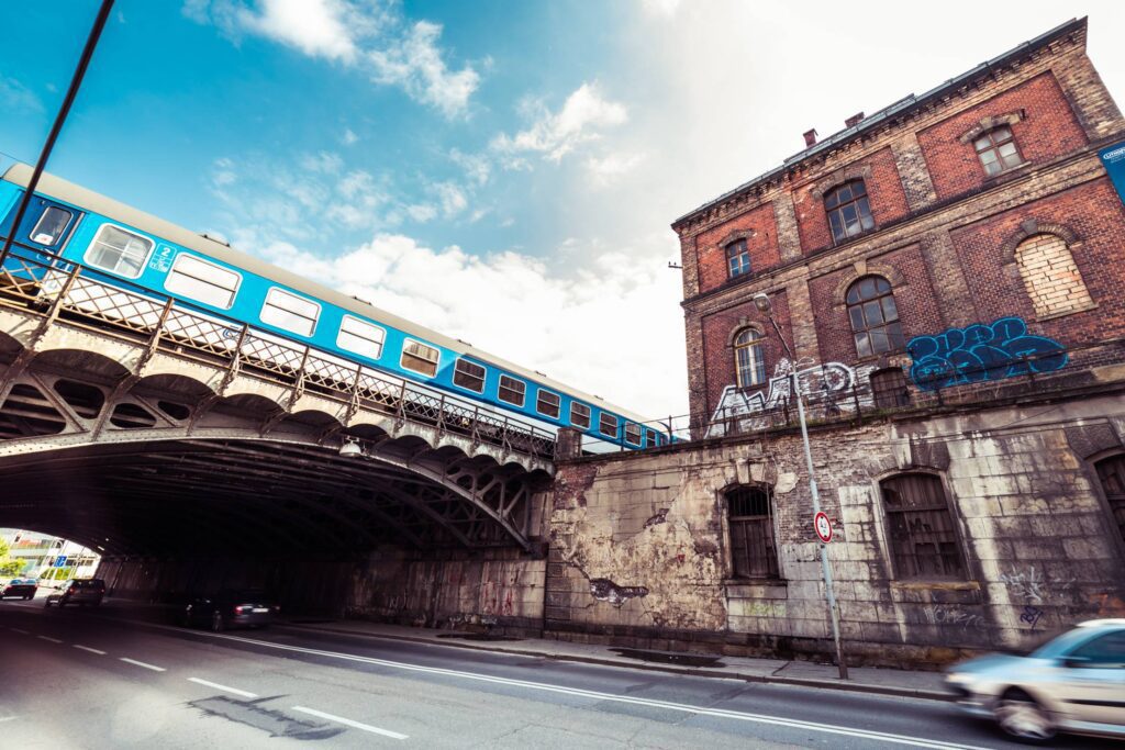 Old Abandoned Building with Steel Railway Bridge Free Photo