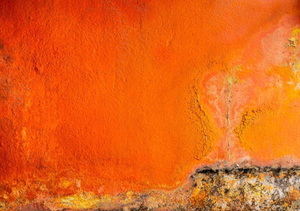 Old and dirty orange color painted on concrete wall texture background with space. Fungus on the house wall Stock Free