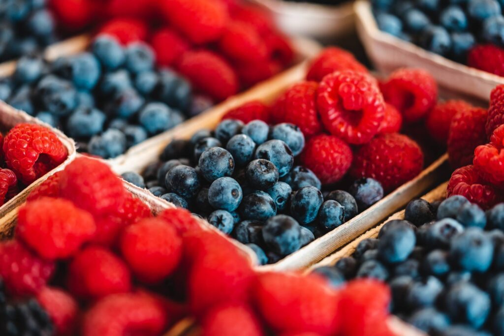 Organic Raspberries and Blueberries on a Farmers Market Free Photo