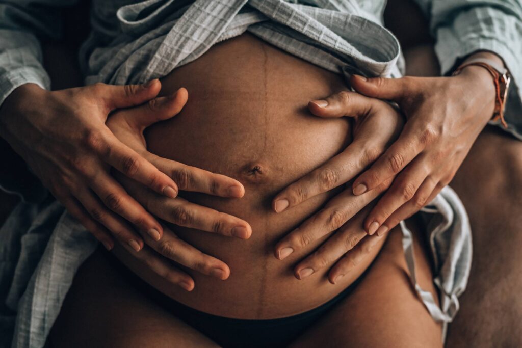 Parents Hands on Pregnant Belly Free Photo