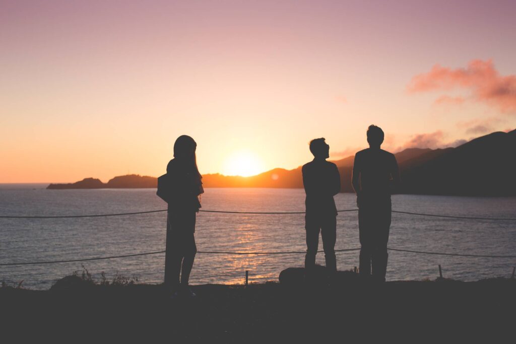 People Enjoying Sunset Over the Ocean Free Photo