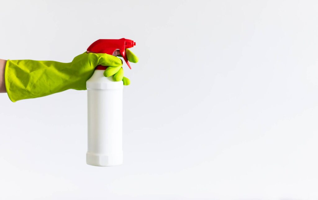 Person Holding a Cleaning Agent Spray Free Photo