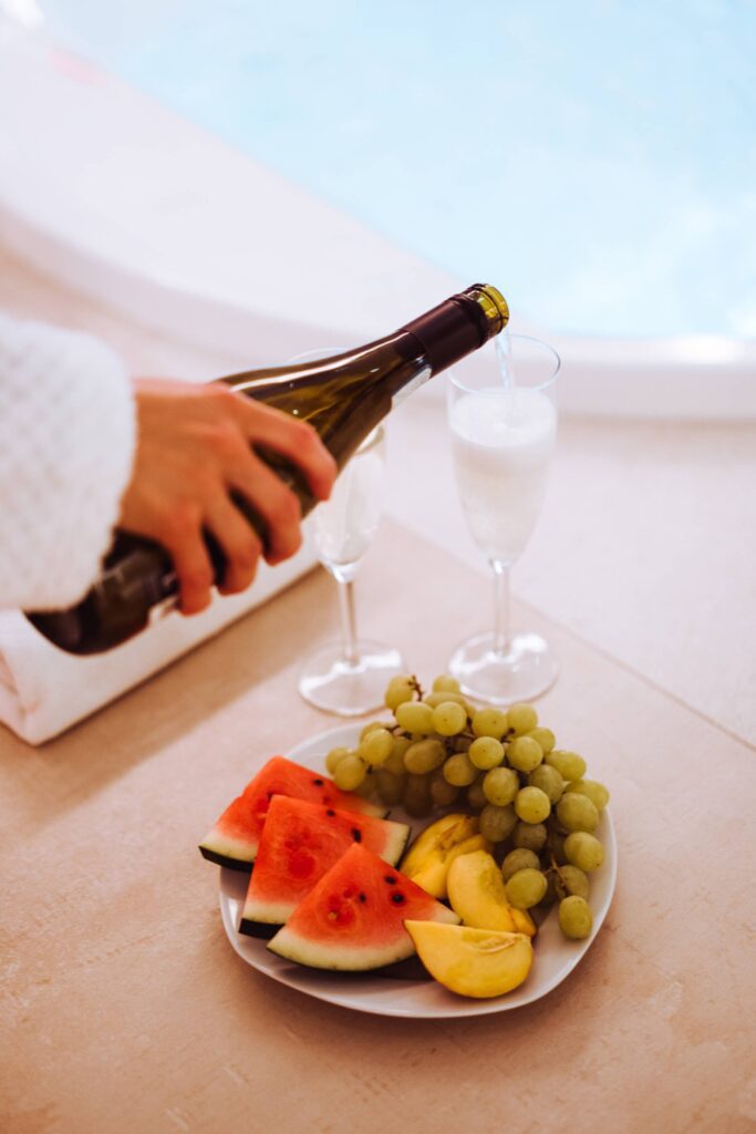 Person Pours Prosecco in Spa Wellness Free Photo