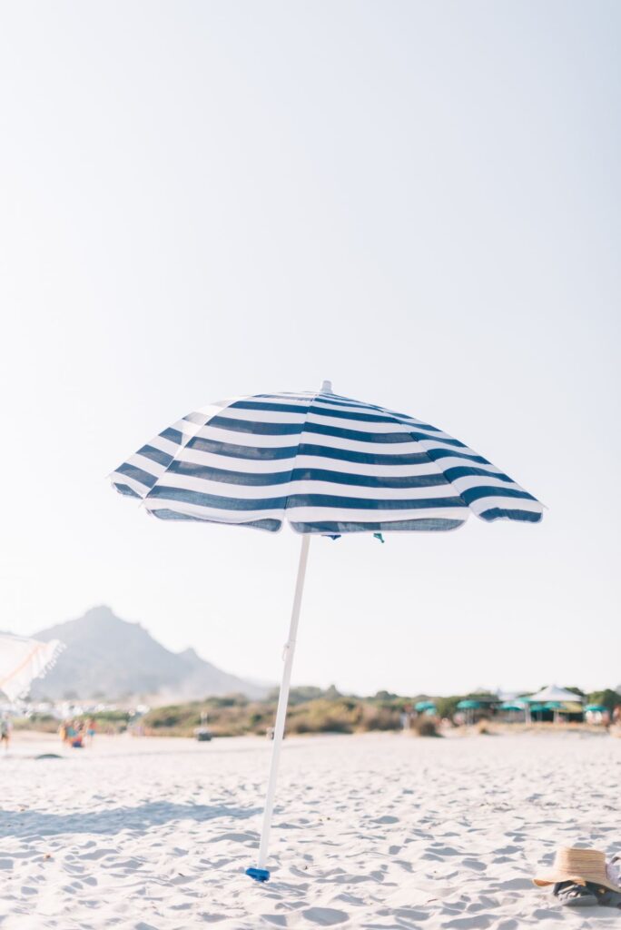 Lonely umbrella on the sandy beach of Sardinia Stock Free