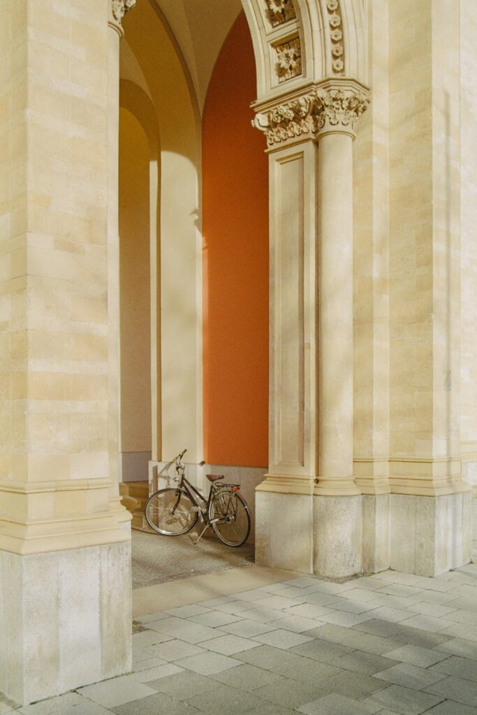 a bike is parked in an archway of a building