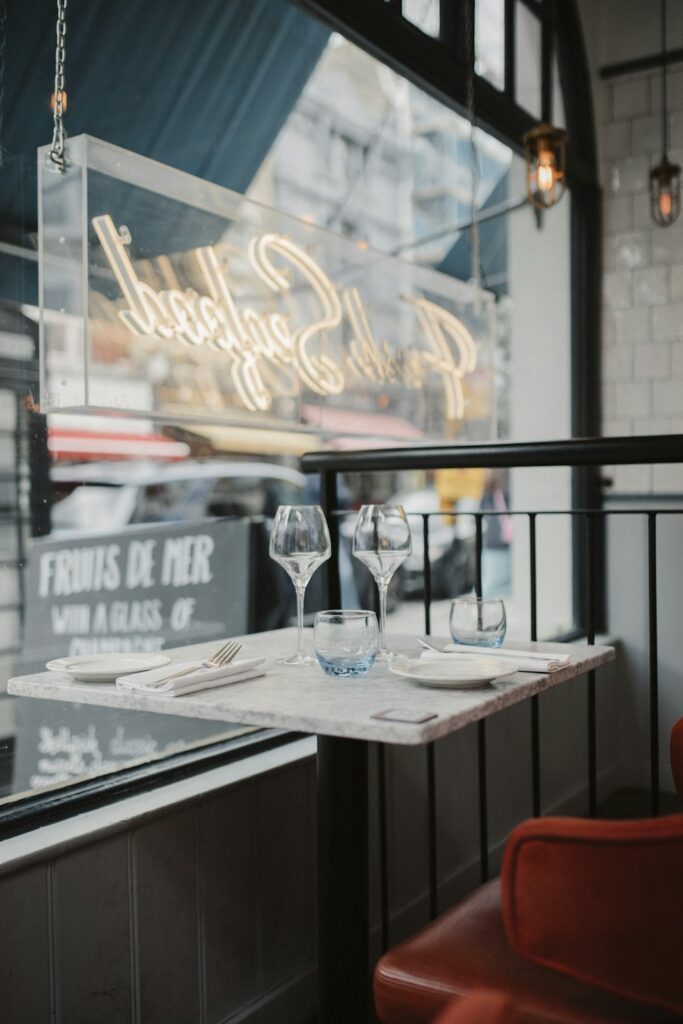 two empty wine glasses sitting on a table in front of a window