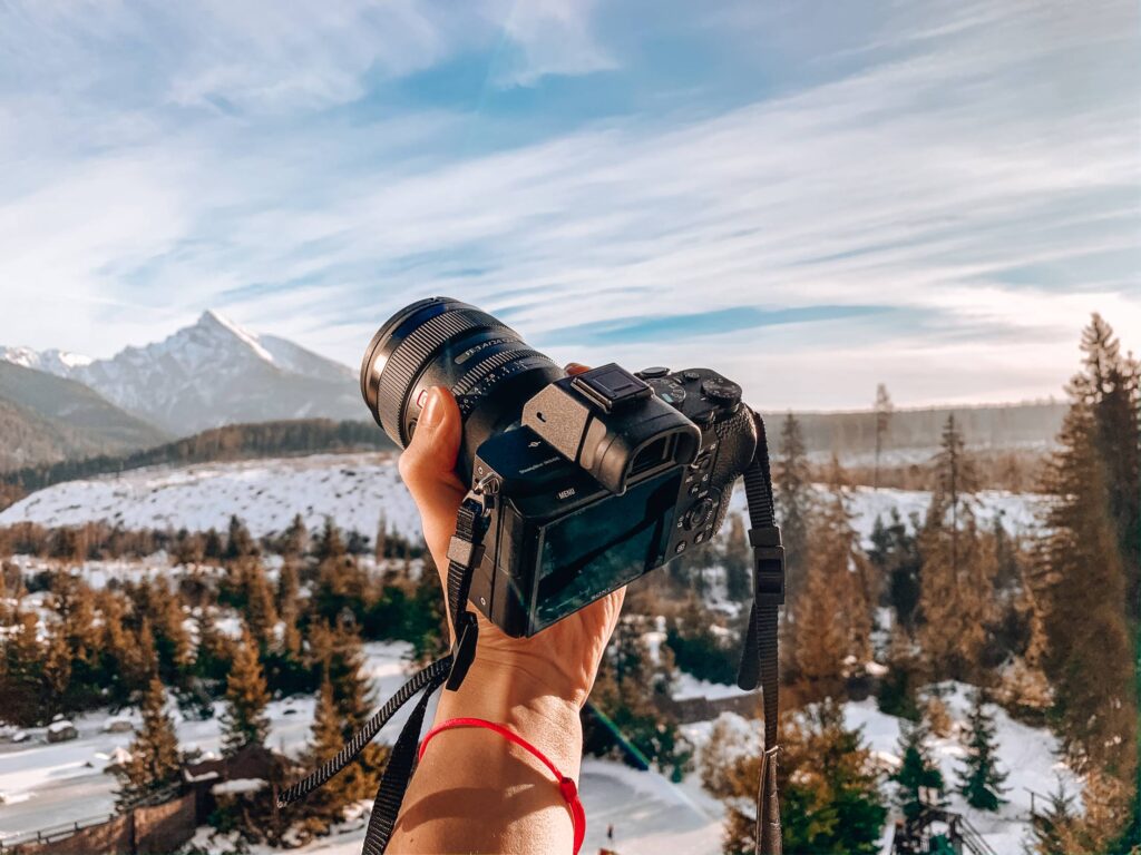 Photographer Holding His Sony Camera in Hand Free Photo