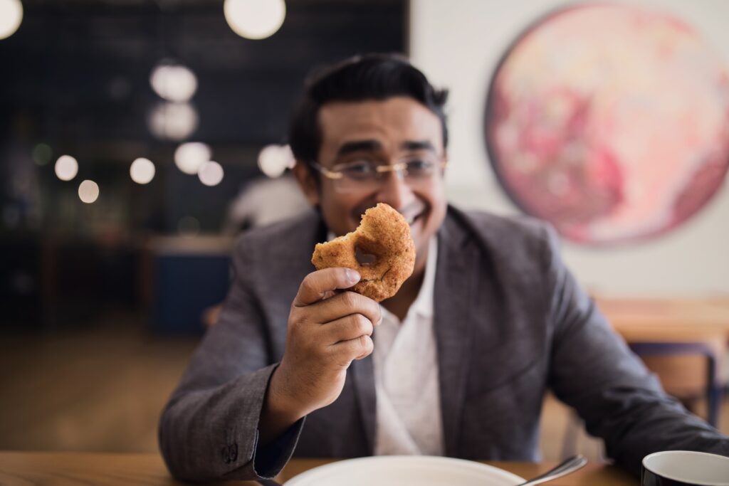 Businessman Holding Donut Free Stock HD Photo