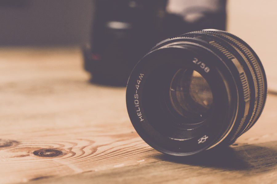 Camera Lens on Wooden Table Free Stock HD Photo