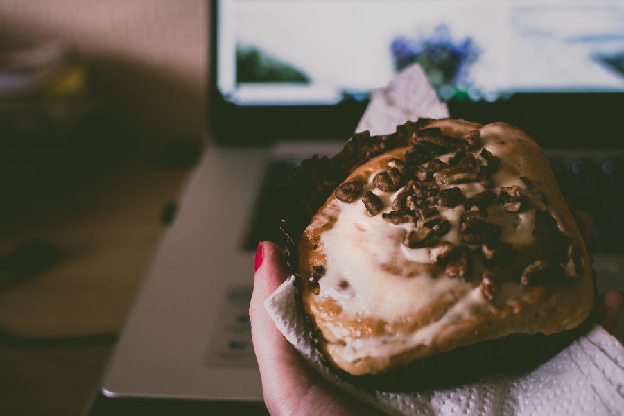 Eating Muffin on Laptop Free Stock HD Photo