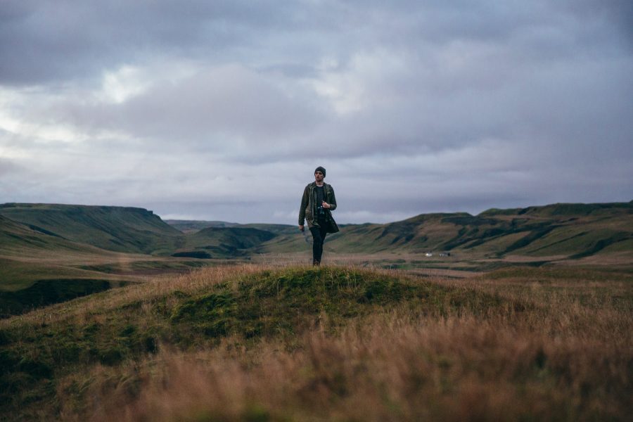 Man Hiking Under Clouds Free Stock HD Photo