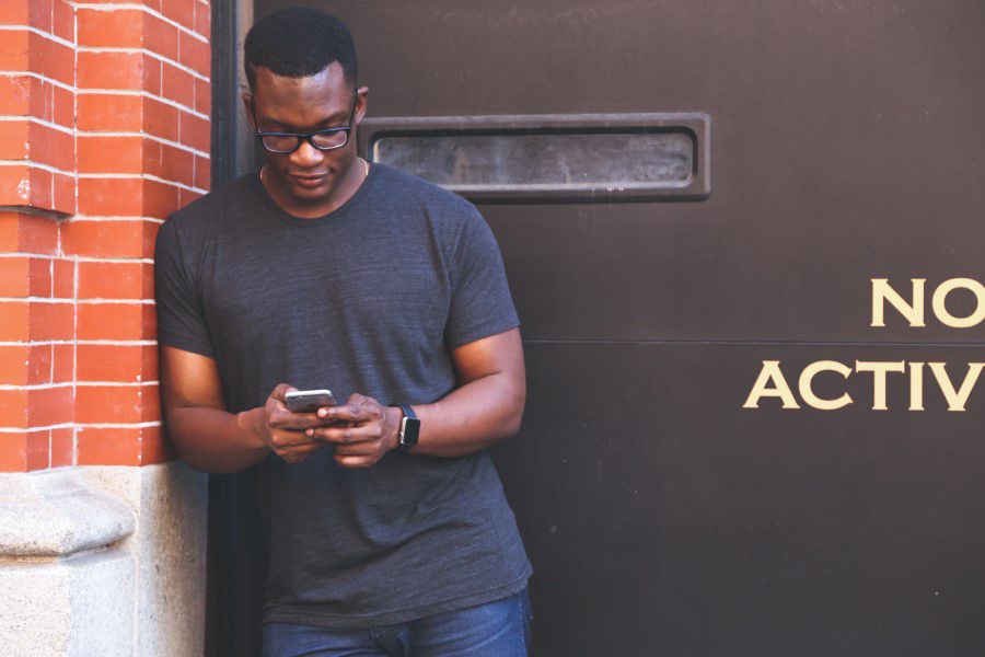 Man Typing on Mobile Phone Free Stock HD Photo