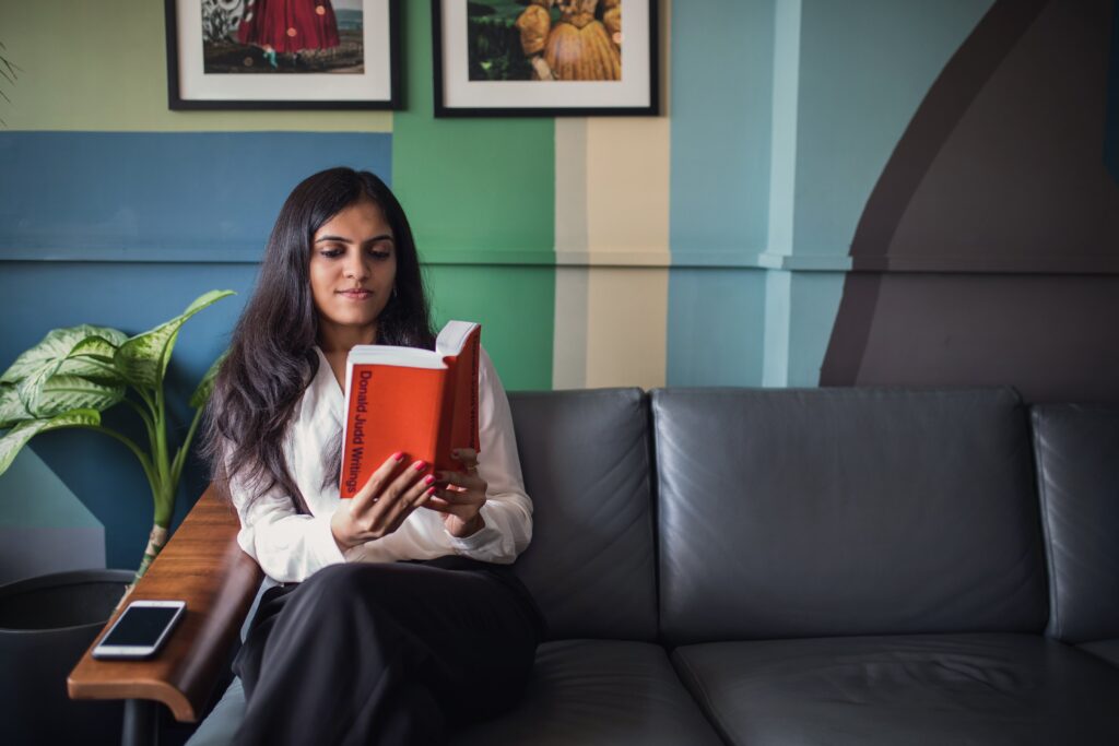 Woman Reading on Couch Free Stock HD Photo