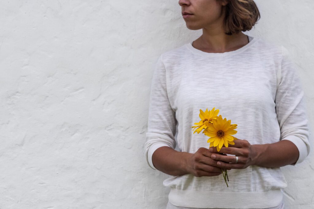 Woman Holding Yellow Flowers Free Stock HD Photo