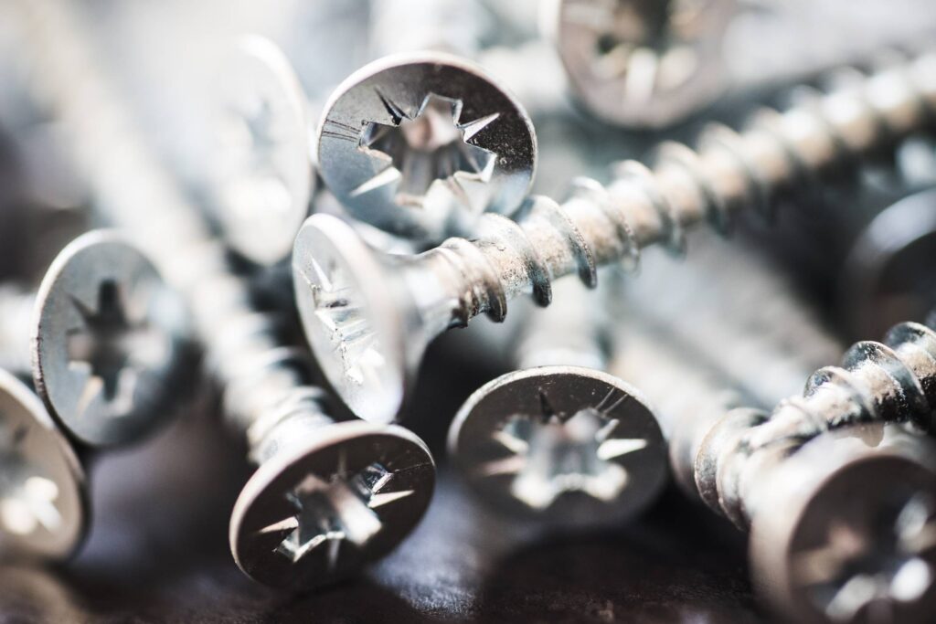 Pile of Silver Flat Crosshead Screws Close Up #1 Free Photo