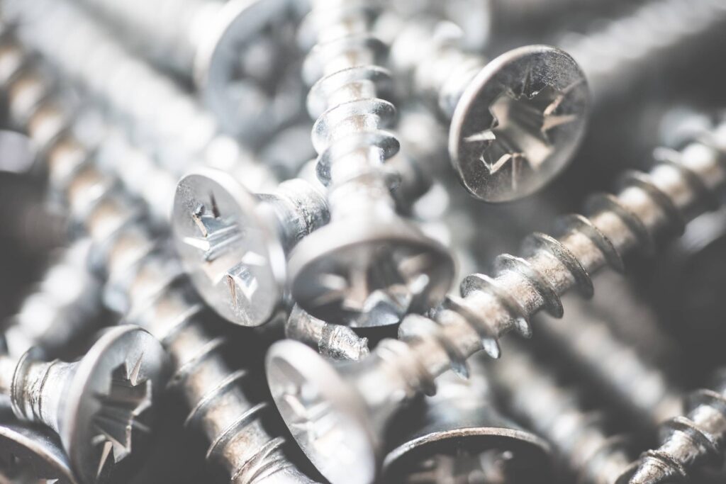 Pile of Silver Flat Crosshead Screws Close Up #2 Free Photo