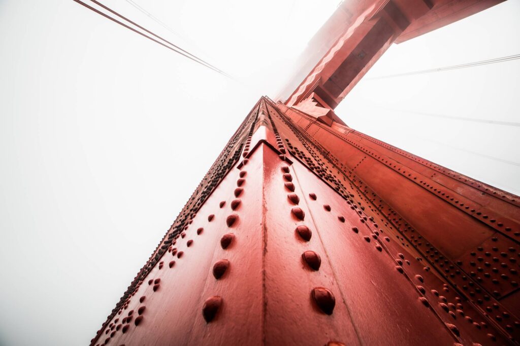 Pillar of The Golden Gate Bridge Against Foggy Sky Free Photo