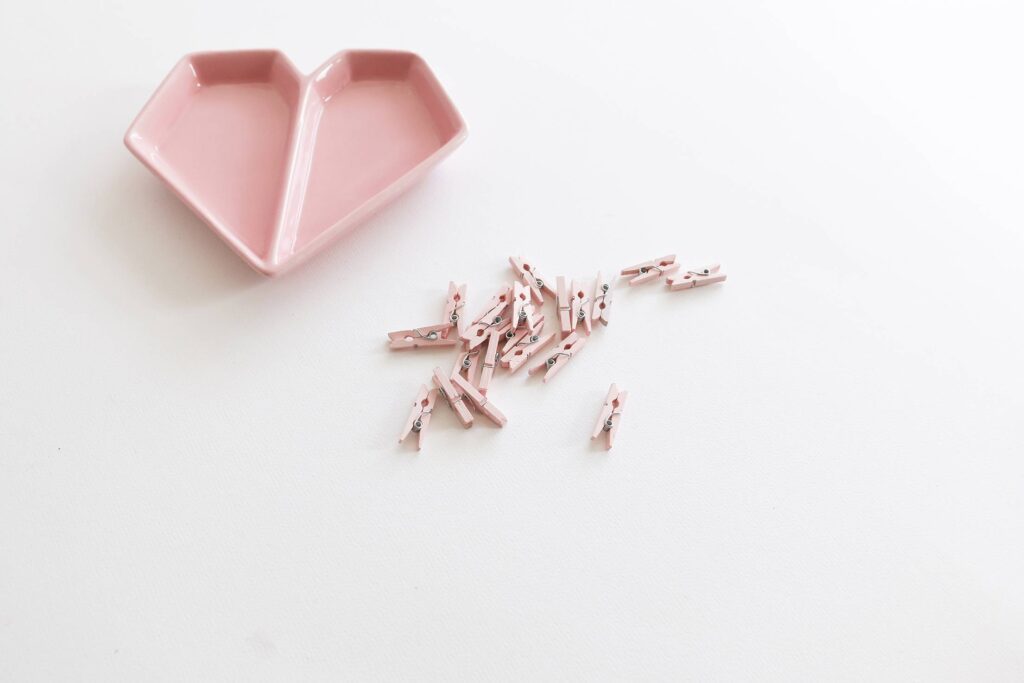 Pink Heart-Shaped Plate with Mini Wooden Pegs Free Photo