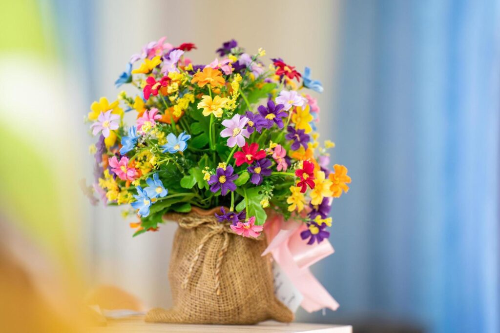 plastic flower In a rope basket, on a desk, in the house Free Photo