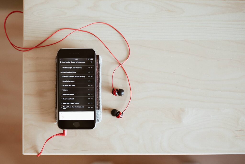 Playing Music with Red Earphones Free Photo