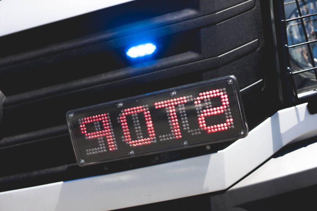 Police Flashing Light and STOP Sign on Car Mirrored Free Photo