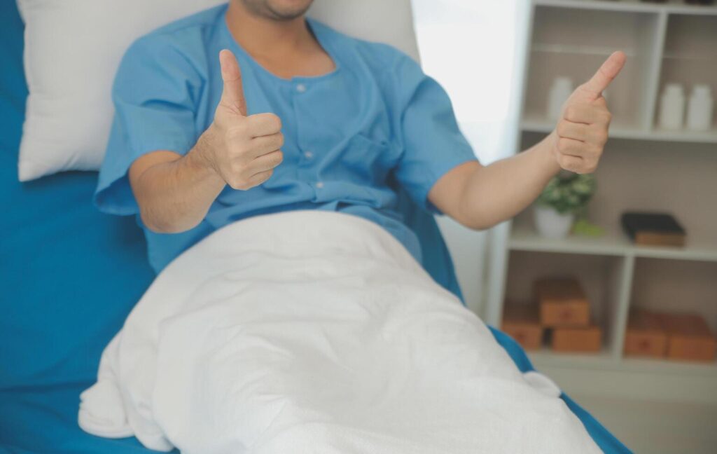 Portrait of happy caucasian sick patient on bed in hospital in medical and healthcare treatment at nursing home or clinic. People lifestyle Stock Free