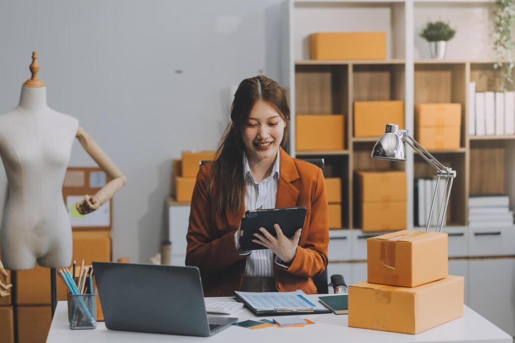 Portrait of Starting small businesses owners female entrepreneurs working on receipt box and check online orders to prepare to pack the boxes, sell to customers, sme business ideas online. Stock Free