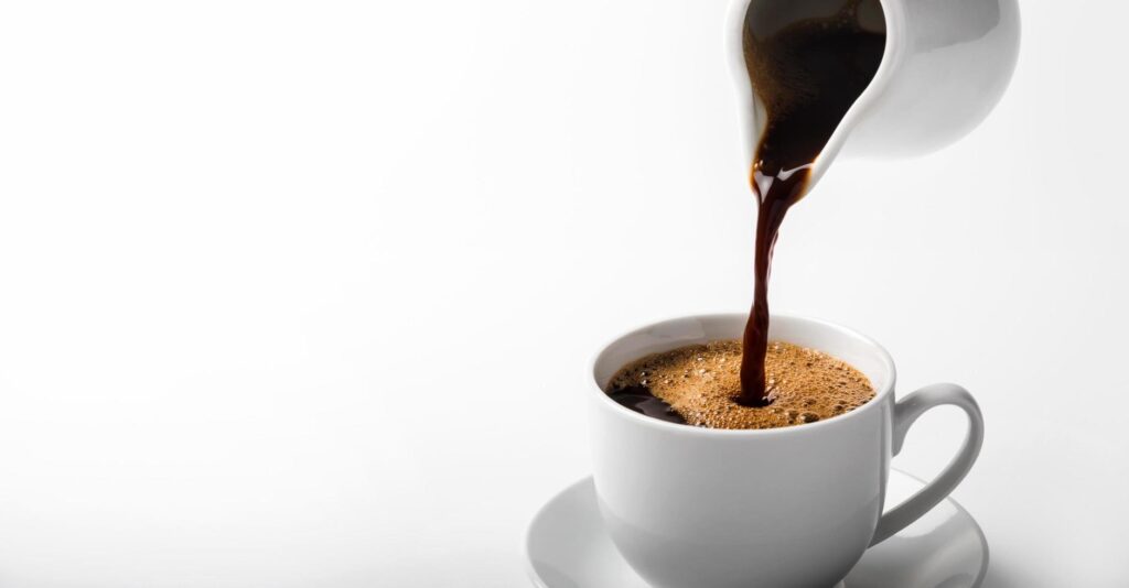 pouring a cup of coffee over white background Stock Free