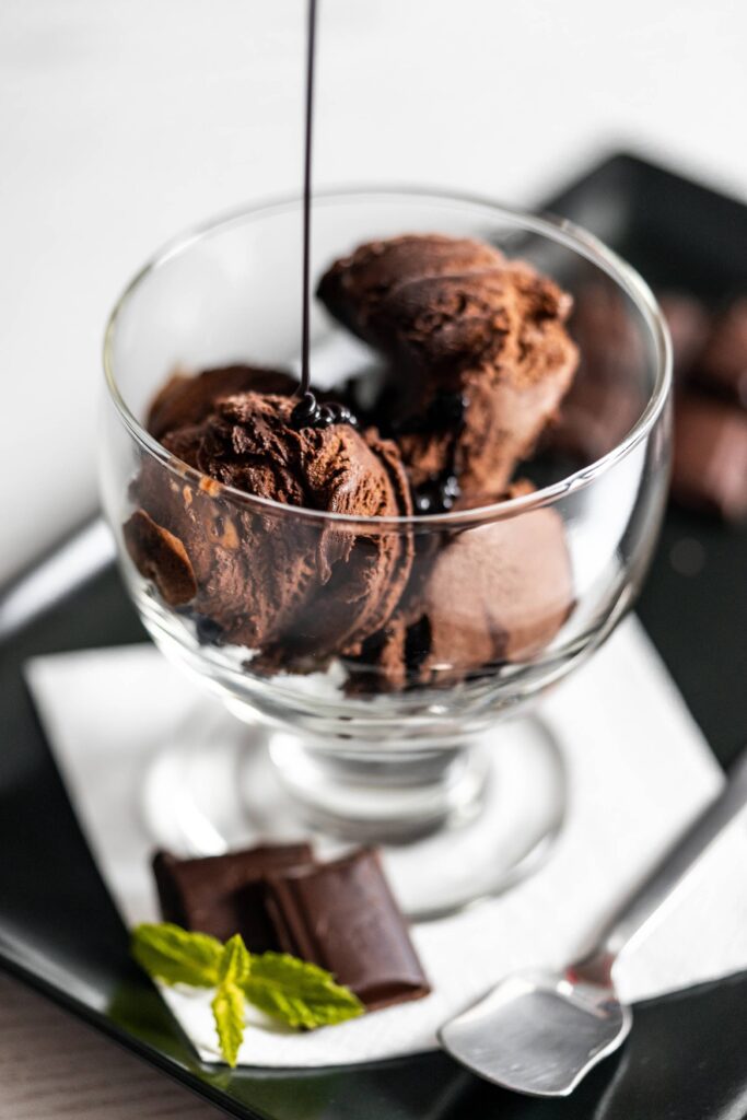 Pouring Chocolate Topping on The Ice-cream Sundae Free Photo