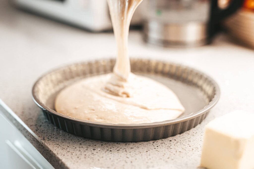 Pouring Dough into a Baking Pan Free Photo