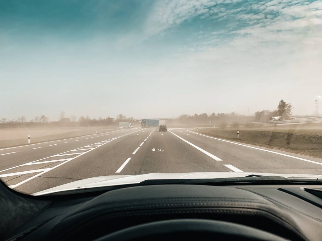 POV Driving a Car Through Dust From Fields Free Photo