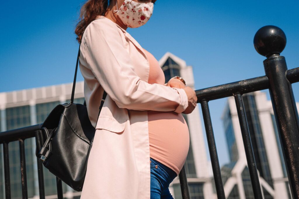 Pregnant Woman Wearing a Face Mask on a Street Free Photo