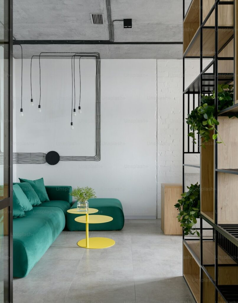 a living room with a green couch and a yellow table